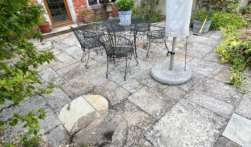 Before: an old patio of cracked, uneven slabs